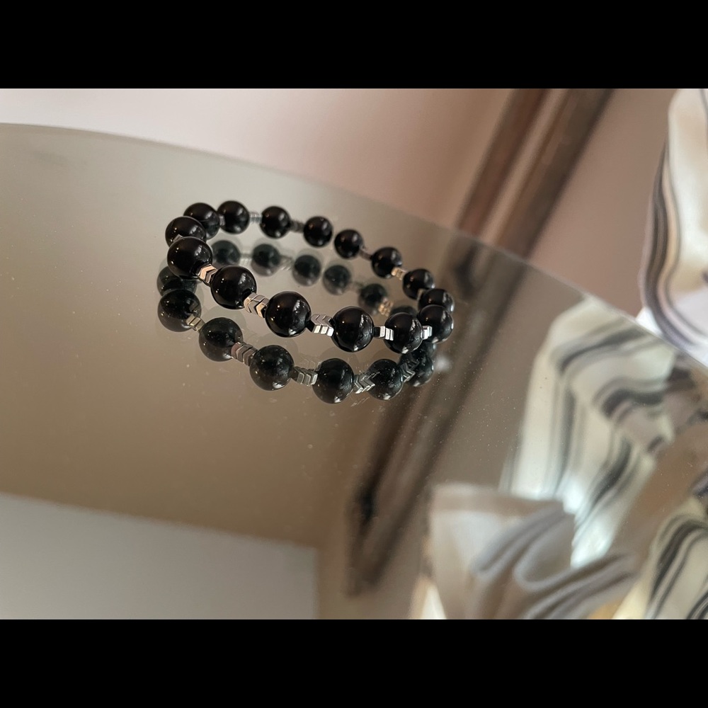 Handcrafted black beaded bracelet with silver chevron accent beads